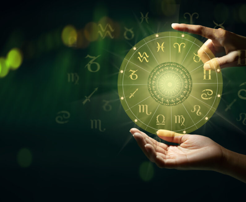 Human predicts the future. Zodiac sign wheel of fortune hologram with mandala inside. Deep green and life graph background. Copy space.